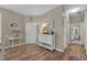 Light-filled hallway with hardwood floors, a decorative table, and soft neutral walls for a welcoming ambiance at 27121 White Plains Way, Leesburg, FL 34748