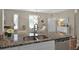 Updated kitchen featuring granite countertops, stainless steel appliances, and hardwood flooring for a modern aesthetic at 27121 White Plains Way, Leesburg, FL 34748