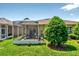 Backyard view with screened lanai, offering a relaxing outdoor space at 27121 White Plains Way, Leesburg, FL 34748