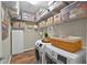 Well-organized laundry room with shelving, a washer and dryer, and ample storage space at 27121 White Plains Way, Leesburg, FL 34748