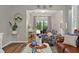 Bright living room featuring a desk, comfortable seating, and a view to the lanai at 27121 White Plains Way, Leesburg, FL 34748