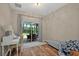 Office area with view of the lanai and neutral colors at 27121 White Plains Way, Leesburg, FL 34748