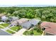 Aerial view of a residential neighborhood with lush landscaping and well-kept homes at 27302 Stoney Brook Dr, Leesburg, FL 34748