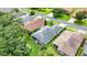Aerial view of a well-maintained home with a screened lanai and lush green lawn at 27302 Stoney Brook Dr, Leesburg, FL 34748