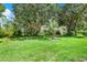 Expansive backyard features mature trees and lush green grass at 27302 Stoney Brook Dr, Leesburg, FL 34748