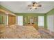 Spacious main bedroom with ensuite bathroom boasts lots of storage, plush carpets, and natural light at 27302 Stoney Brook Dr, Leesburg, FL 34748