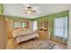 Bright main bedroom with ensuite bathroom boasts lots of storage, plush carpets, and natural light at 27302 Stoney Brook Dr, Leesburg, FL 34748