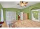 Well-lit bedroom features hardwood flooring and closet with sliding glass doors with direct access to backyard at 27302 Stoney Brook Dr, Leesburg, FL 34748
