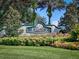 Landscaped entrance to the Legacy of Leesburg community, featuring lush greenery and a decorative sign at 27302 Stoney Brook Dr, Leesburg, FL 34748