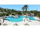 Inviting community pool area with ample seating, palm trees, and clear blue water at 27302 Stoney Brook Dr, Leesburg, FL 34748