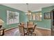 Comfortable dining room featuring laminate floors, overhead lighting, and a bright window at 27302 Stoney Brook Dr, Leesburg, FL 34748