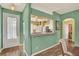 Inviting entryway with white door, travertine floors, and an open view to the kitchen at 27302 Stoney Brook Dr, Leesburg, FL 34748