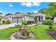 Inviting single-story home with manicured lawn, flowering plants and a two-car garage at 27302 Stoney Brook Dr, Leesburg, FL 34748