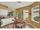 Bright eat-in kitchen featuring white cabinets, granite countertops, stainless appliances, and breakfast bar at 27302 Stoney Brook Dr, Leesburg, FL 34748