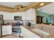 White cabinets, granite counters, and stainless steel appliances make this kitchen stylish and functional at 27302 Stoney Brook Dr, Leesburg, FL 34748