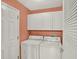Convenient laundry room features a washer, dryer, and storage cabinets at 27302 Stoney Brook Dr, Leesburg, FL 34748