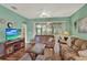 Bright living room with large windows, comfortable seating, and laminate flooring at 27302 Stoney Brook Dr, Leesburg, FL 34748