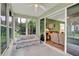 Enclosed sunroom with multiple windows offering relaxing views of the yard at 27302 Stoney Brook Dr, Leesburg, FL 34748