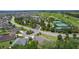 Panoramic aerial showcases nearby tennis courts and golf course amidst an established neighborhood at 2954 Heiny Pl, The Villages, FL 32163