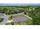 Aerial view of a home in a golf course community featuring tennis courts and beautifully landscaped surroundings at 2954 Heiny Pl, The Villages, FL 32163