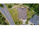 Aerial perspective of a house showcasing its roof, surrounding landscaping, and proximity to nearby streets at 2954 Heiny Pl, The Villages, FL 32163