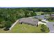 An aerial view of the rear of this beige home shows a large yard and white fence line at 2954 Heiny Pl, The Villages, FL 32163