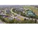 Golf course and tennis courts view from property with manicured lawns and mature landscaping at 2954 Heiny Pl, The Villages, FL 32163