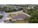 View of roof of house and yard, surrounded by trees and greenery in a neighborhood setting at 2954 Heiny Pl, The Villages, FL 32163