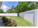 Private backyard with white perimeter fencing and manicured lawn and hedges at 2954 Heiny Pl, The Villages, FL 32163
