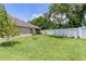 Expansive backyard showcasing a pristine lawn and a privacy fence, ideal for outdoor activities at 2954 Heiny Pl, The Villages, FL 32163