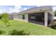 Well-maintained backyard featuring lush green grass and a screened-in lanai for outdoor enjoyment at 2954 Heiny Pl, The Villages, FL 32163