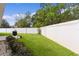A beautifully maintained backyard features a white fence and lush green lawn at 2954 Heiny Pl, The Villages, FL 32163