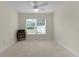 Bedroom featuring neutral walls, carpet, and a window with a ceiling fan to circulate fresh air at 2954 Heiny Pl, The Villages, FL 32163