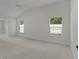 Well-lit bedroom with neutral carpeting and two windows offering ample natural light at 2954 Heiny Pl, The Villages, FL 32163