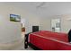 Spacious bedroom with a ceiling fan, TV, and easy access to a bathroom and another room at 2954 Heiny Pl, The Villages, FL 32163