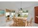 Bright dining room featuring sliding glass doors to outdoor patio and a charming chandelier at 2954 Heiny Pl, The Villages, FL 32163