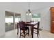 Dining area with dark wood table, chandelier, and sliding glass doors to the patio at 2954 Heiny Pl, The Villages, FL 32163