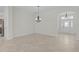 Open entryway featuring tile flooring, chandelier, and decorative front door at 2954 Heiny Pl, The Villages, FL 32163