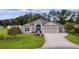 Well maintained single-story home with a three-car garage, beautiful landscaping, and mature trees at 2954 Heiny Pl, The Villages, FL 32163