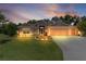 Charming home with a well-manicured lawn, enhanced by elegant exterior lighting and a neatly kept driveway at 2954 Heiny Pl, The Villages, FL 32163