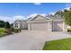 Charming single-story home features a spacious three-car garage and well-manicured lawn at 2954 Heiny Pl, The Villages, FL 32163