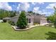 Well-maintained front yard with lush landscaping and beautiful curb appeal at 2954 Heiny Pl, The Villages, FL 32163