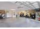 Spacious garage with storage, workspace, and room for multiple golf carts at 2954 Heiny Pl, The Villages, FL 32163