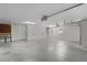 Spacious three car garage featuring work bench and multiple garage doors at 2954 Heiny Pl, The Villages, FL 32163