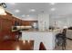 Bright kitchen with granite counters, stainless steel appliances, wooden cabinets, and breakfast bar at 2954 Heiny Pl, The Villages, FL 32163