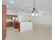 Open concept kitchen with stainless steel appliances, granite countertops, and seamless flow to the living area at 2954 Heiny Pl, The Villages, FL 32163