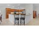 Spacious kitchen featuring wooden cabinetry, stainless steel appliances, and breakfast bar with seating at 2954 Heiny Pl, The Villages, FL 32163