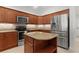 Kitchen features granite countertops, stainless appliances, and a functional island at 2954 Heiny Pl, The Villages, FL 32163