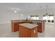 Kitchen island with a sink, countertop seating, and stylish cabinetry at 2954 Heiny Pl, The Villages, FL 32163