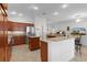 Open-concept kitchen with granite countertops, stainless appliances, and an island at 2954 Heiny Pl, The Villages, FL 32163